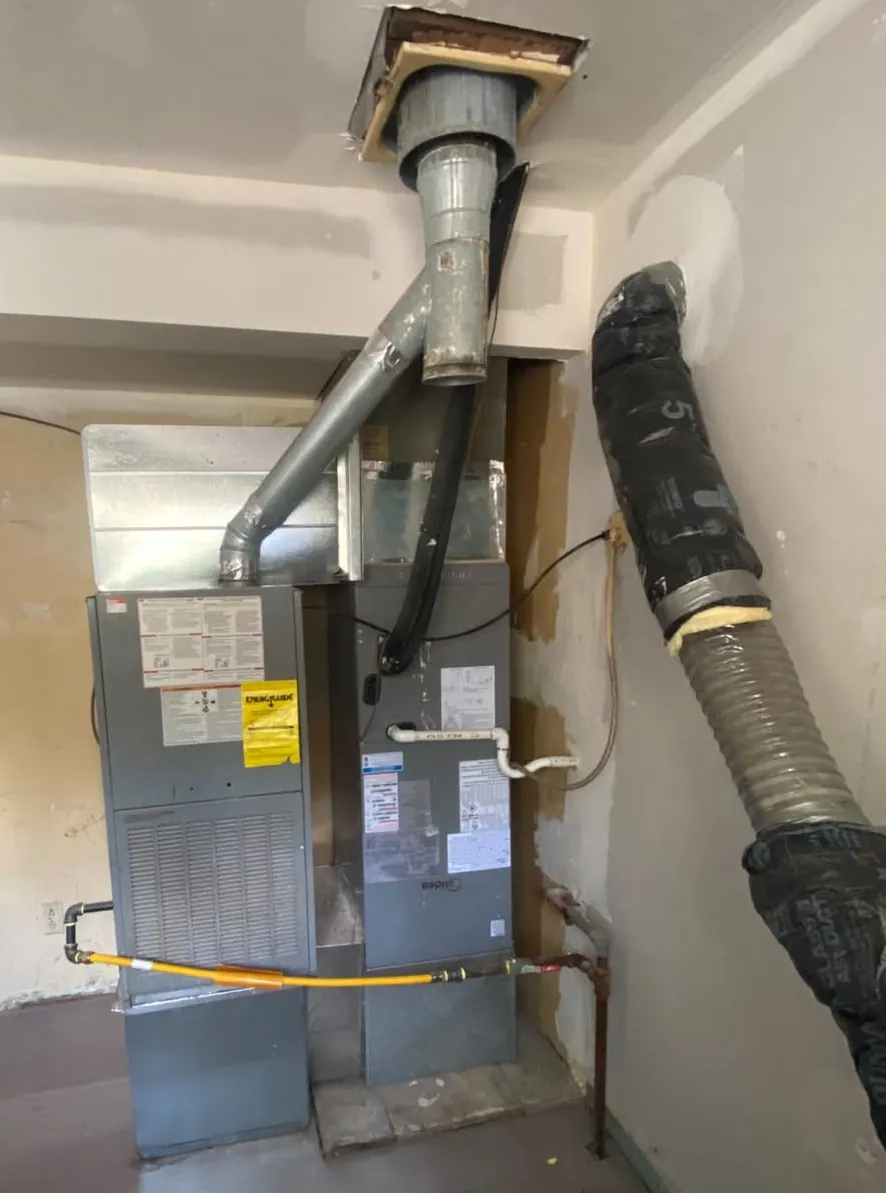 New equipment installed in a mechanical room with venting and ductwork